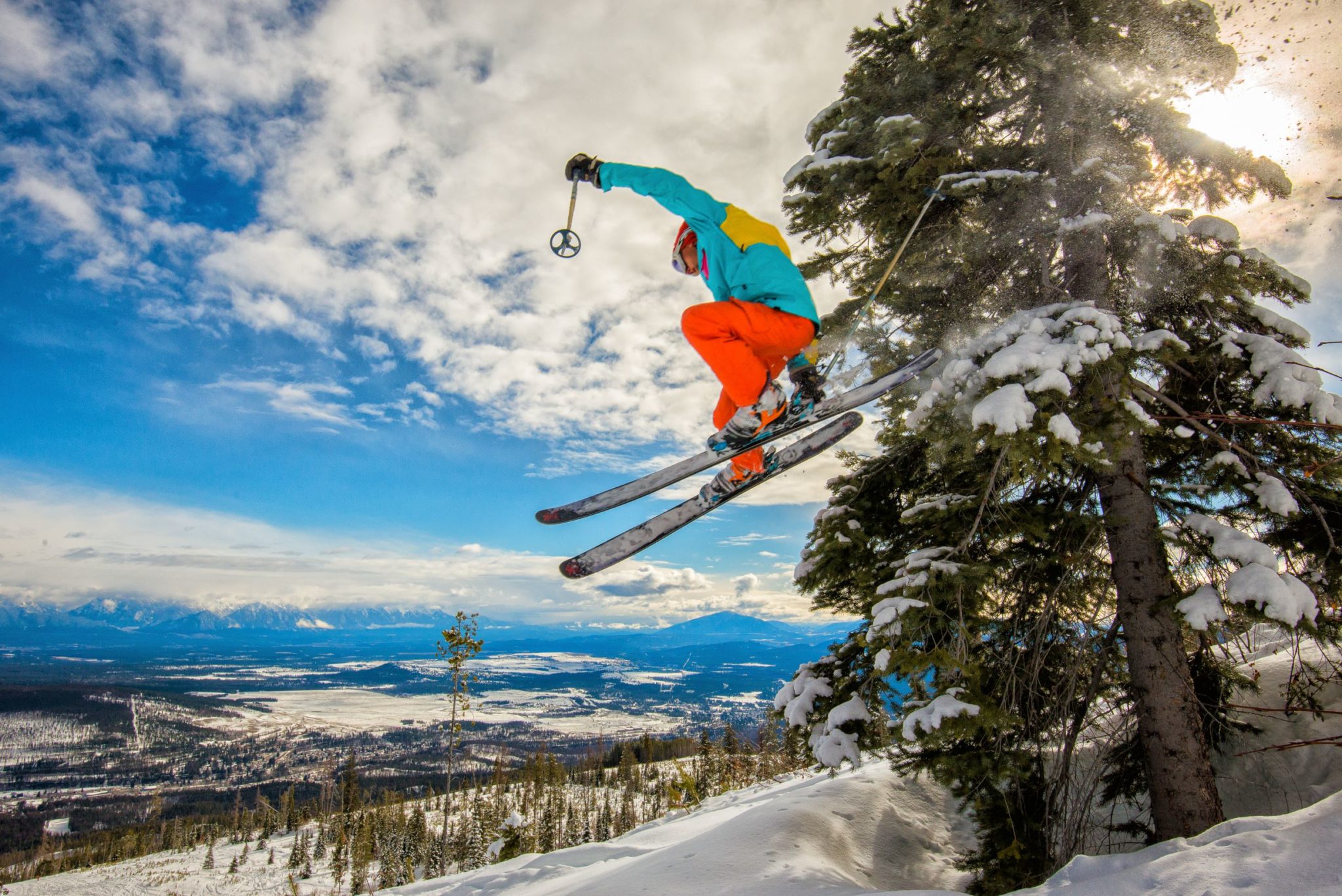 skier jumping into powder snow