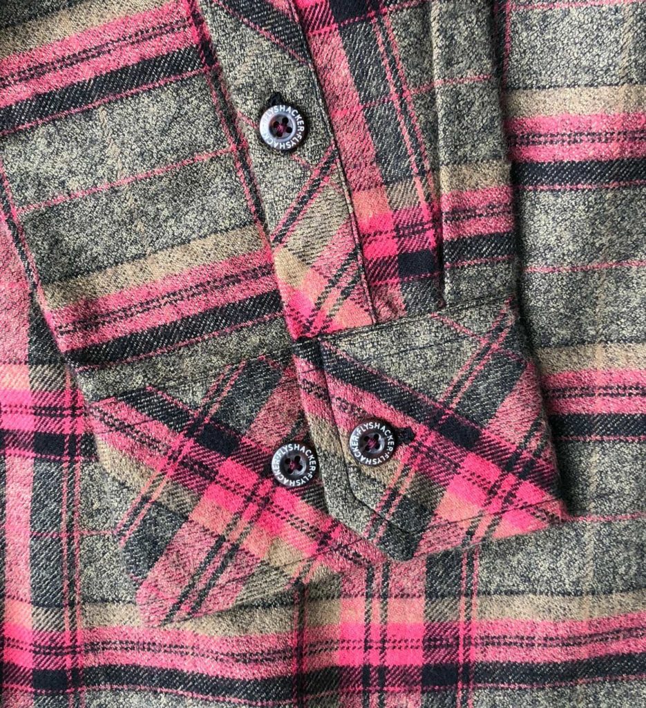 A grey pink and tan plaid flannel shirt.