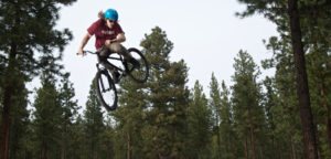 A man on a dirt bike doing a trick jump.