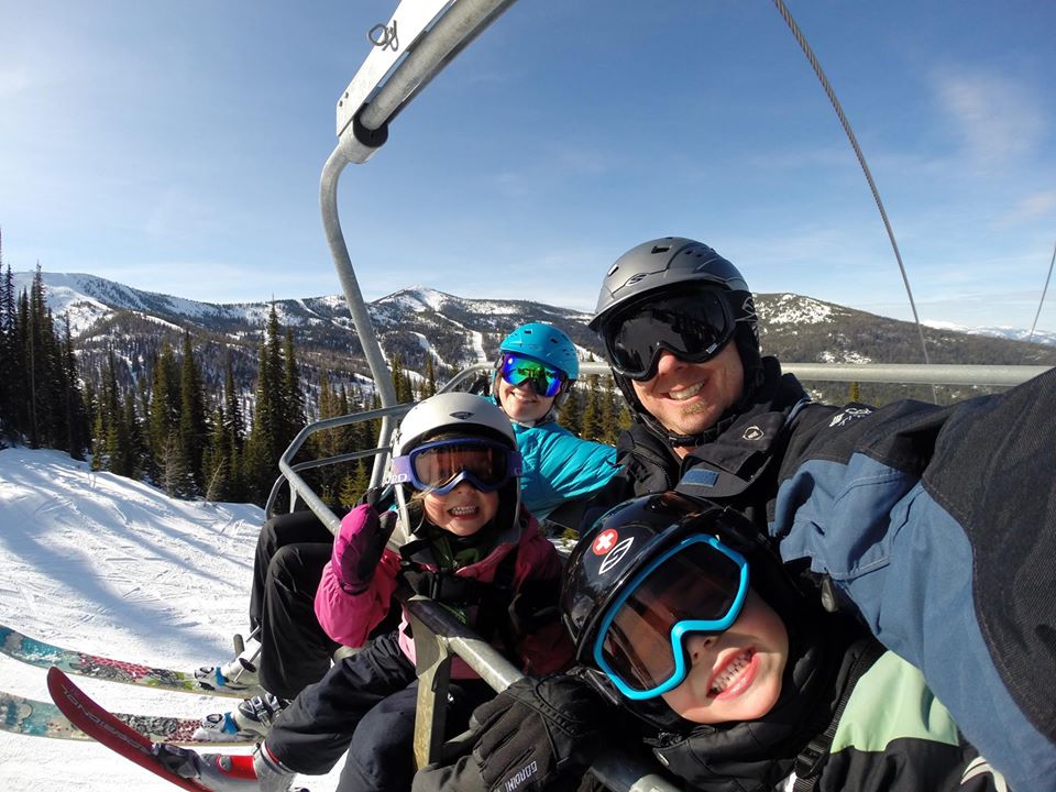 A family selfie on a chair-lift.