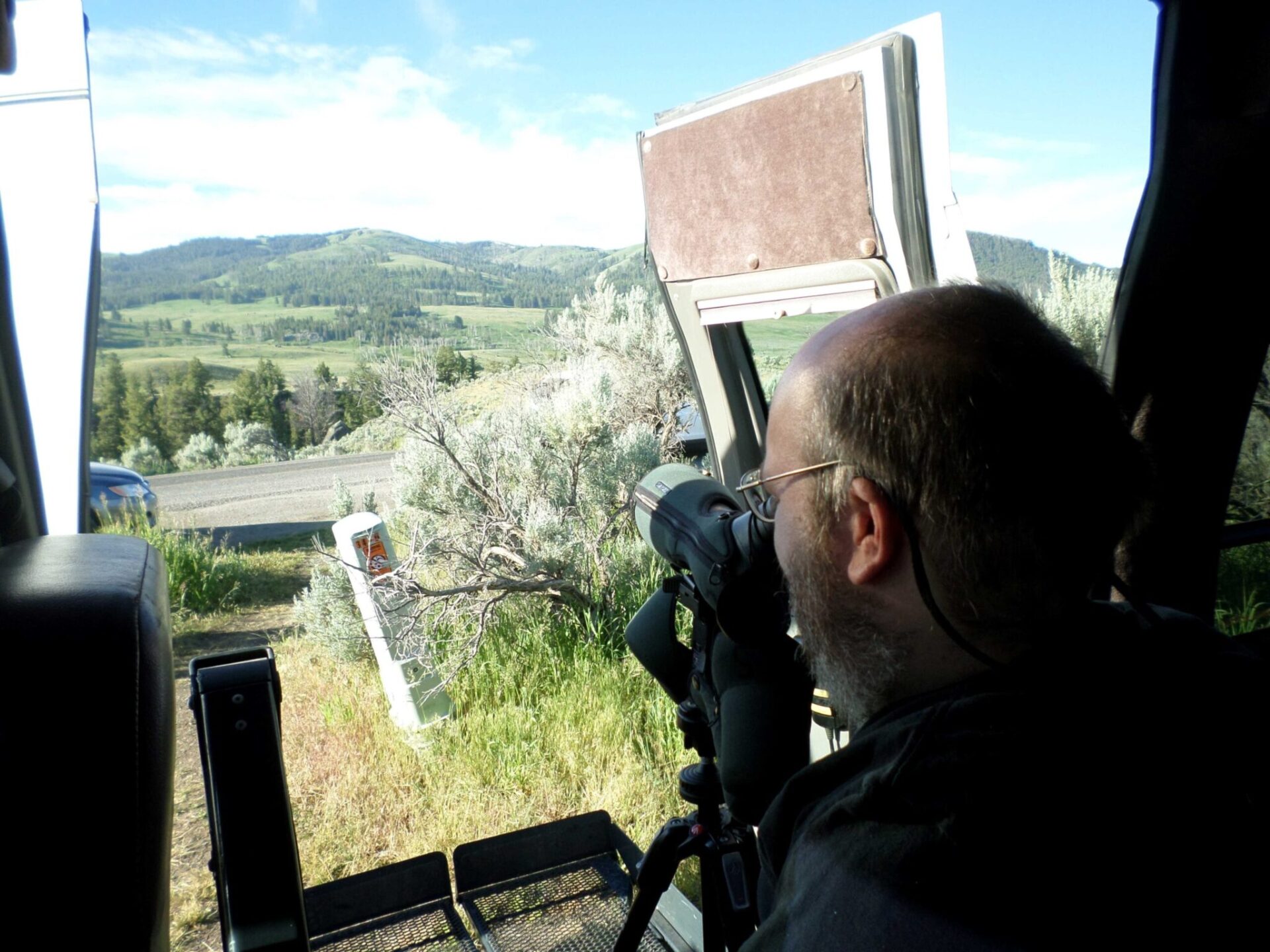 A man using a telescope to view wildlife.