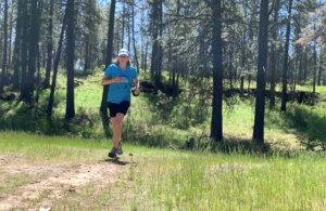 Person running on a forest trail.