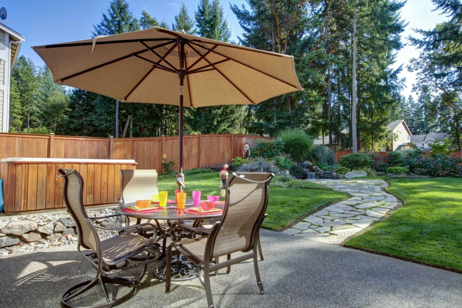 Patio furniture with a manicured lawn behind it.