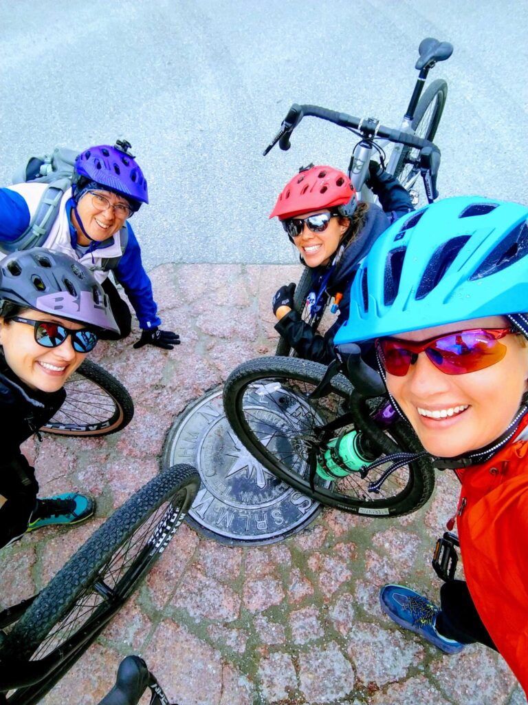 A person taking a selfie with other bike riders.
