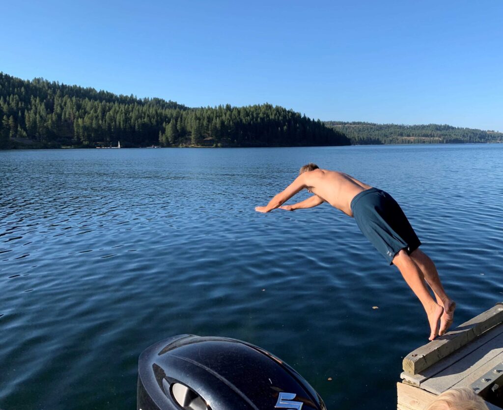 A man diving into a lake.