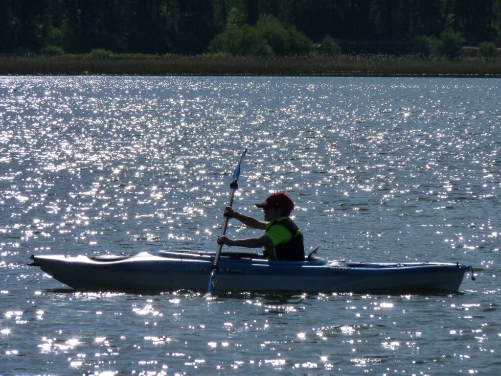 A young boy kayaking.