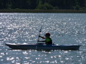 A young boy kayaking.