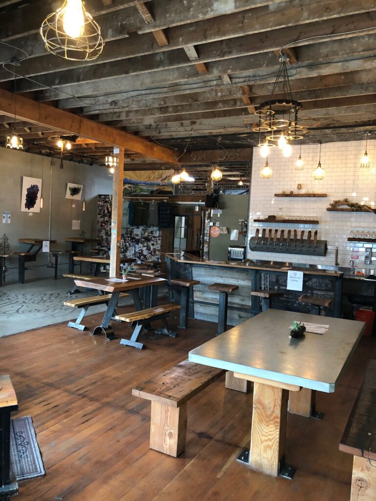 A brewery storefront with exposed ceiling beams.