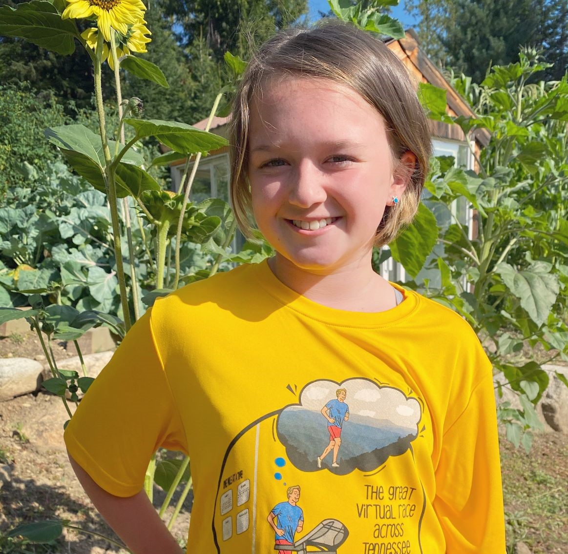 A girl smiling in her garden.