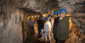 A tour group walking through a mine shaft.