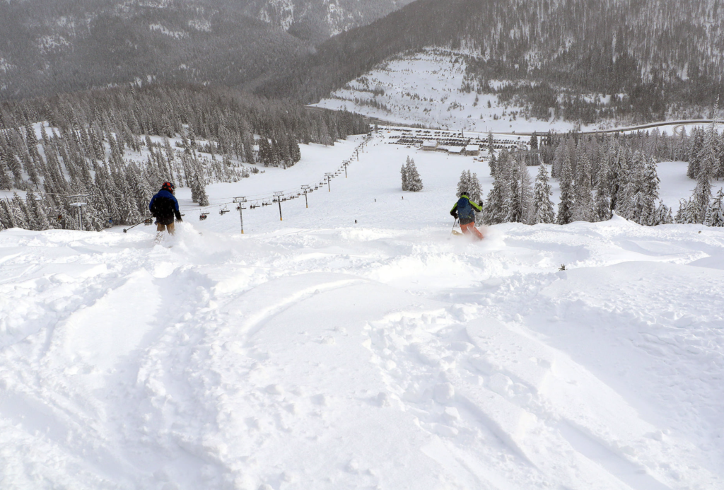 Deep powder on the Idaho side of Lookout Pass Ski & Recreation Area, leading down to the lodge. 