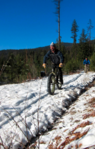 Biking over snow with fat tires.