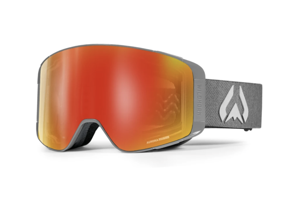 Snow goggles with orange lenses and gray frame and head strap.