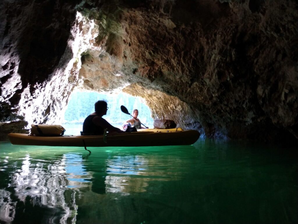 Two kayakers floating in a small cave the Pend Oreille River.