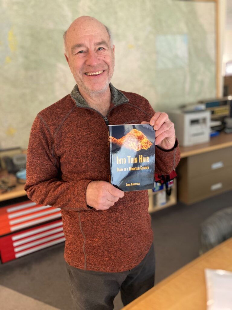 Chris Kopczynski holding his newly published book.