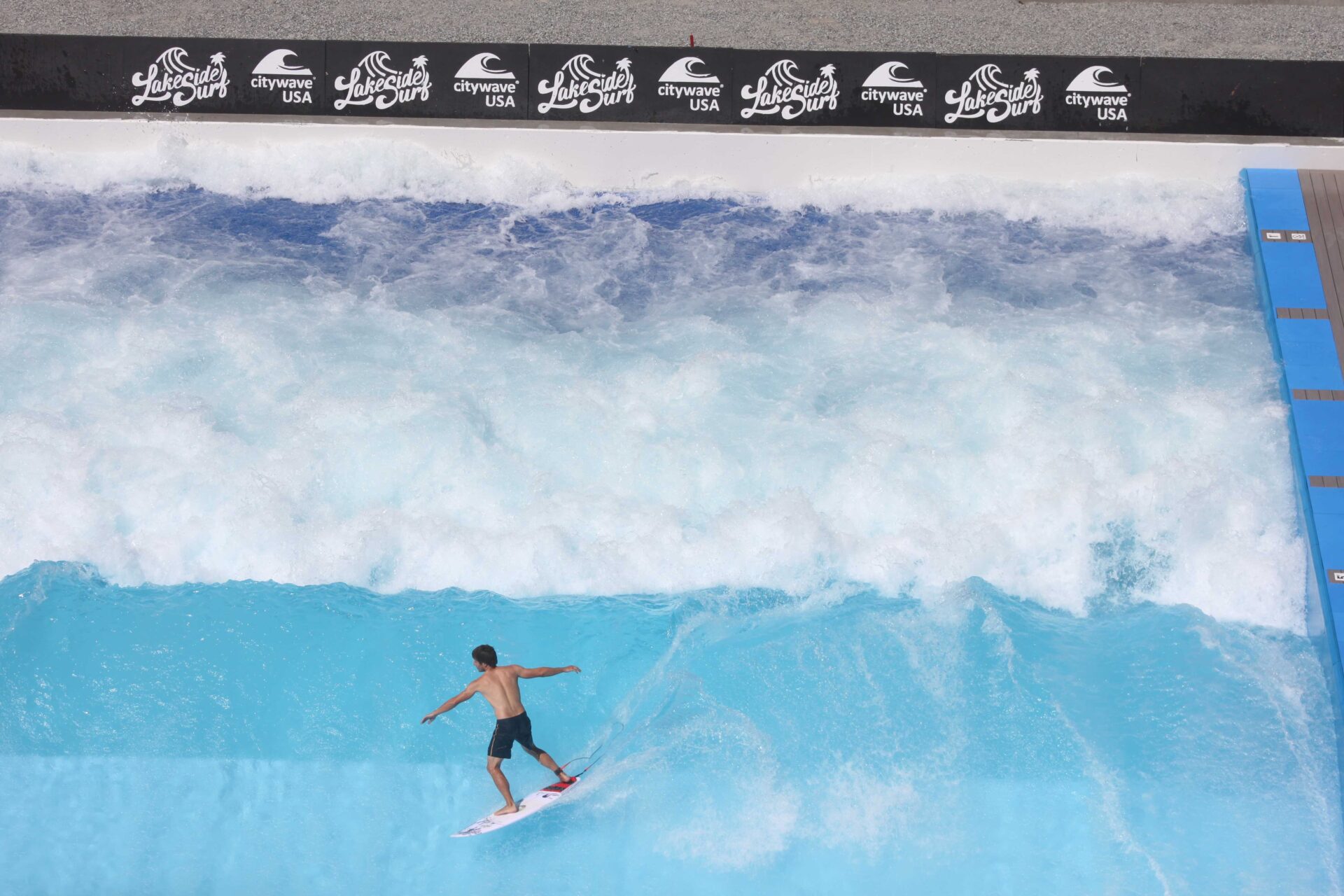 Man surfing a wave, Lakeside Surf, at Slidewaters Waterpark in Chelan, Washington.