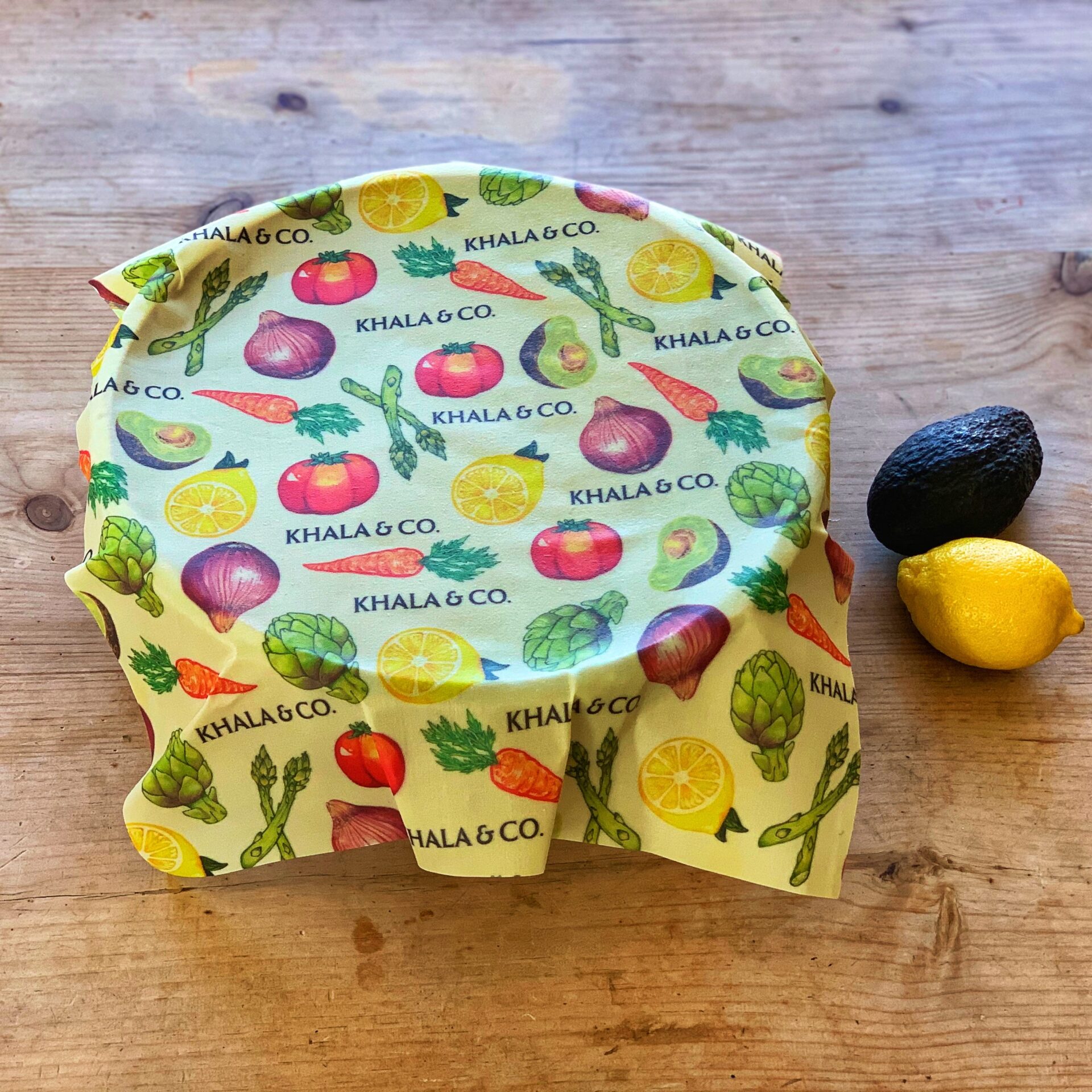 Khala & Company brand reusable food storage wrap -- yellow and vegetable pattern fabric.