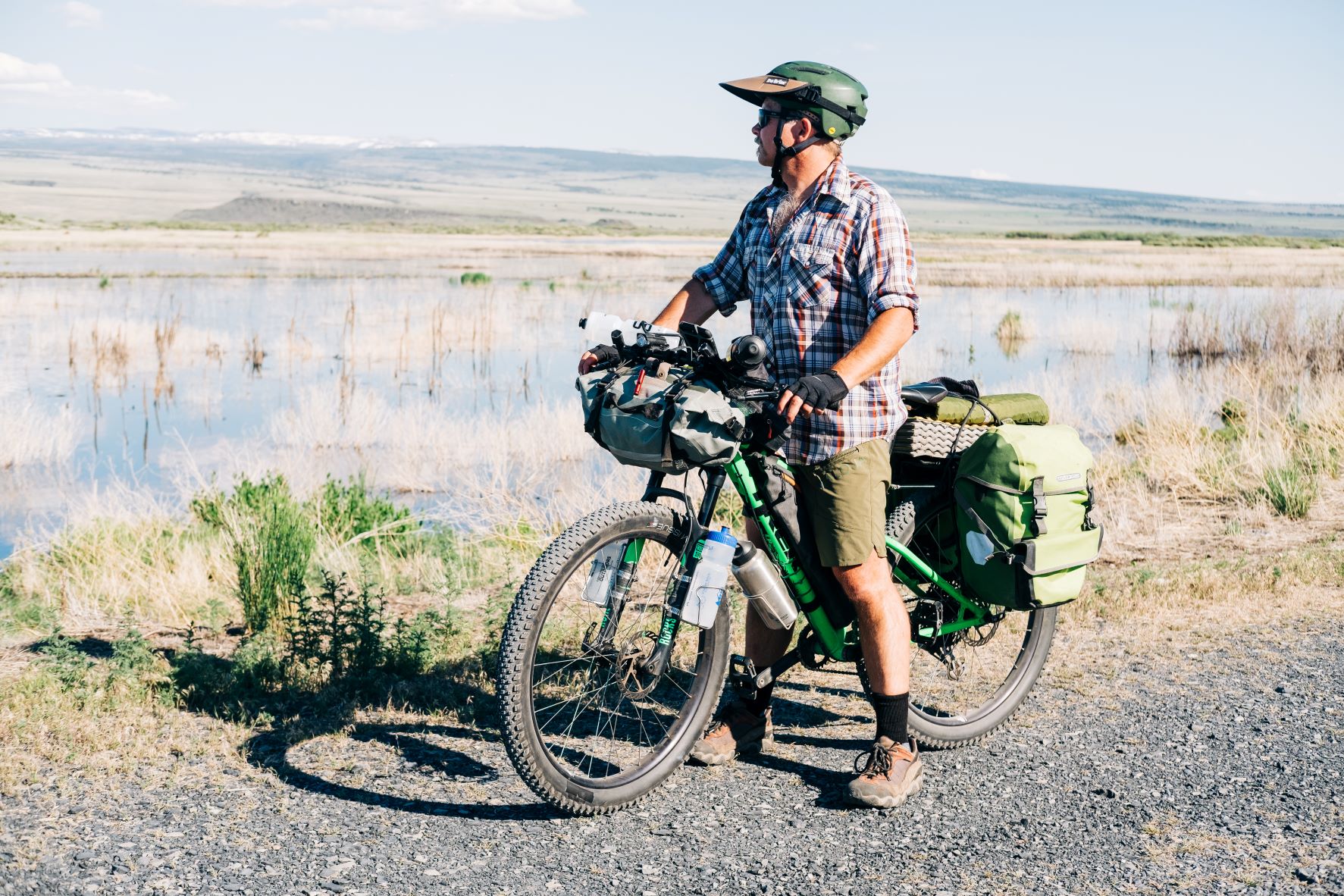 Derrick Knowles on his mountain bike, loaded with gear for bikepacking.