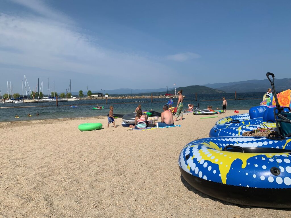 Families on the sandy City Beach in Sandpoint along Lake Pend Oreille.