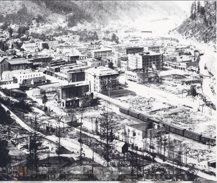Black and white vintage photo of Wallace, Idaho, after the Great Fires of 1910, with burned down buildings.
