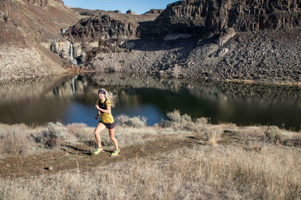 Runner on a dirt trail in the wilderness.