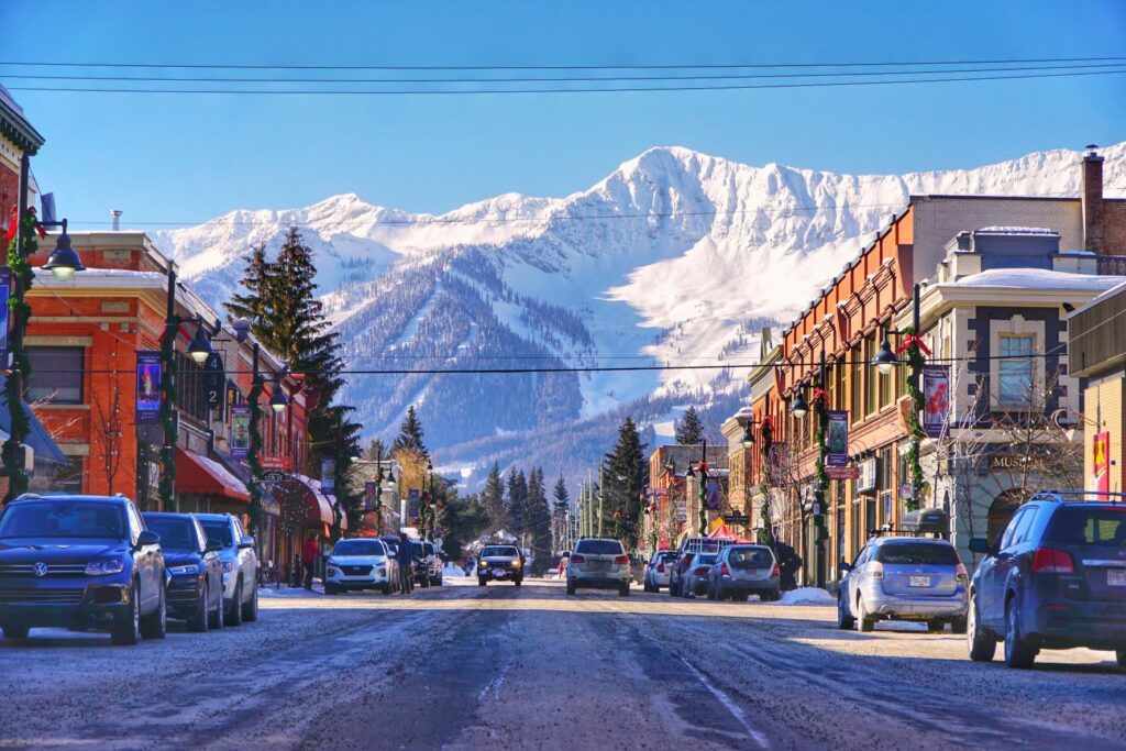 Downtown Fernie, B.C. with brick buildings of main street and awesome view of East Kootenay mountains laden with snow.