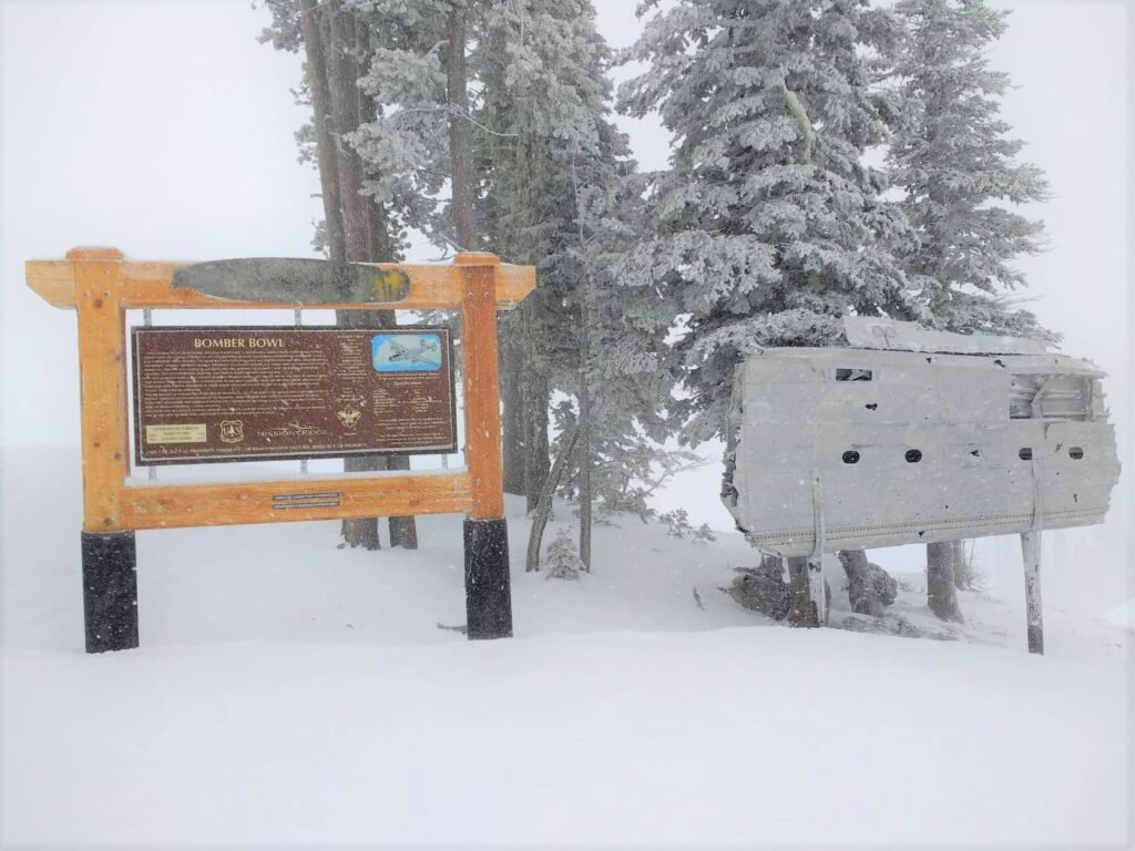 Wooden sign atop a run at Mission Ridge ski area..