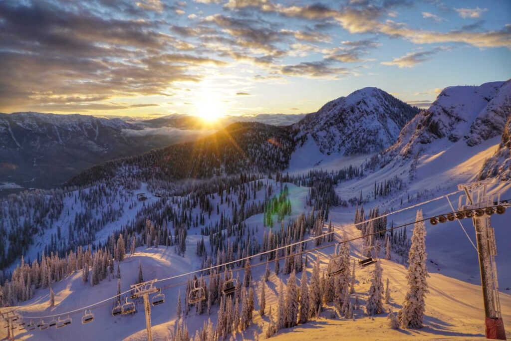 Sunrise peeking over a ridge above a chairlift at Fernie Alpine Resort. 