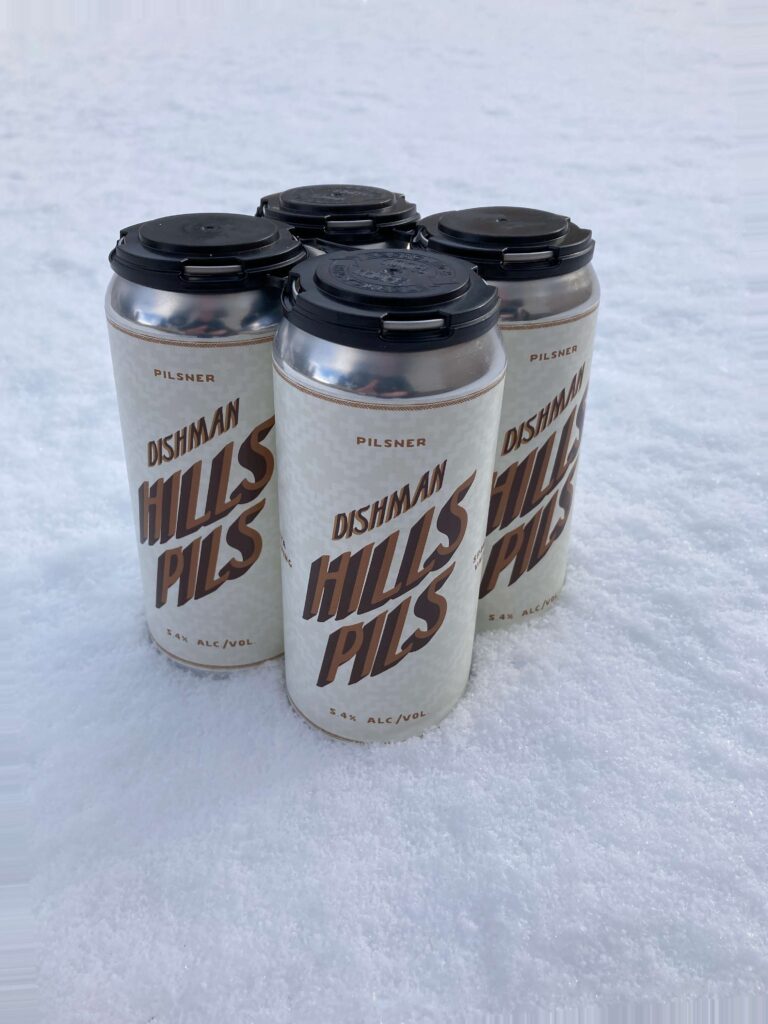 Dishman Hills Pils from YaYa Brewing -- 4 cans sitting in snow.