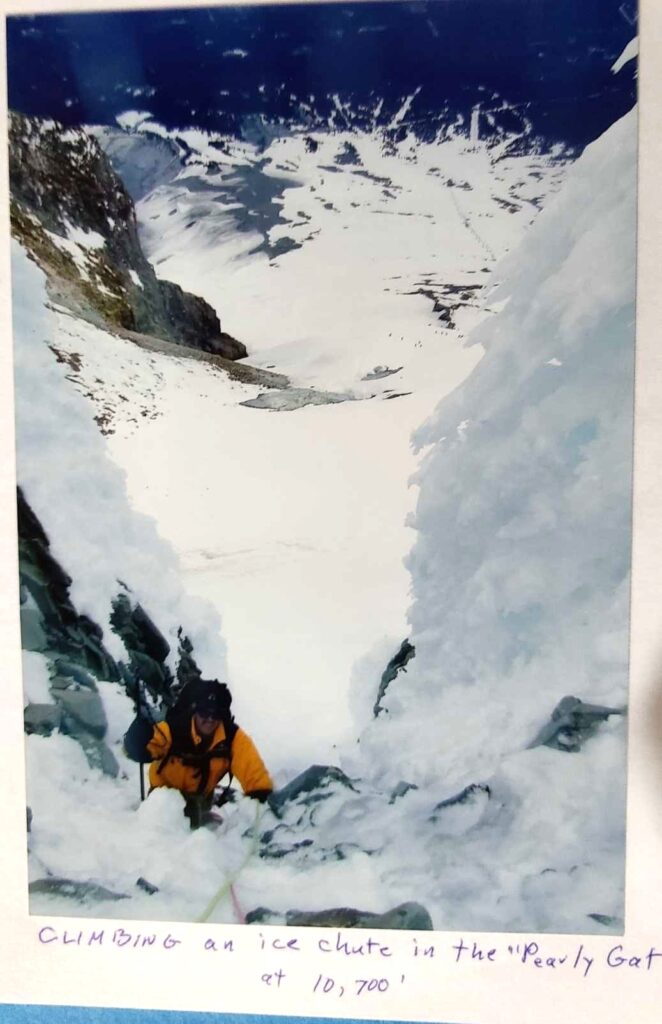 Man climbing Mt. Hood during winter.