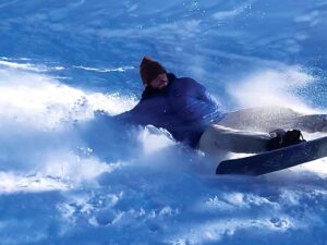 Garrett Shadwick falling down while trying to snowboard.