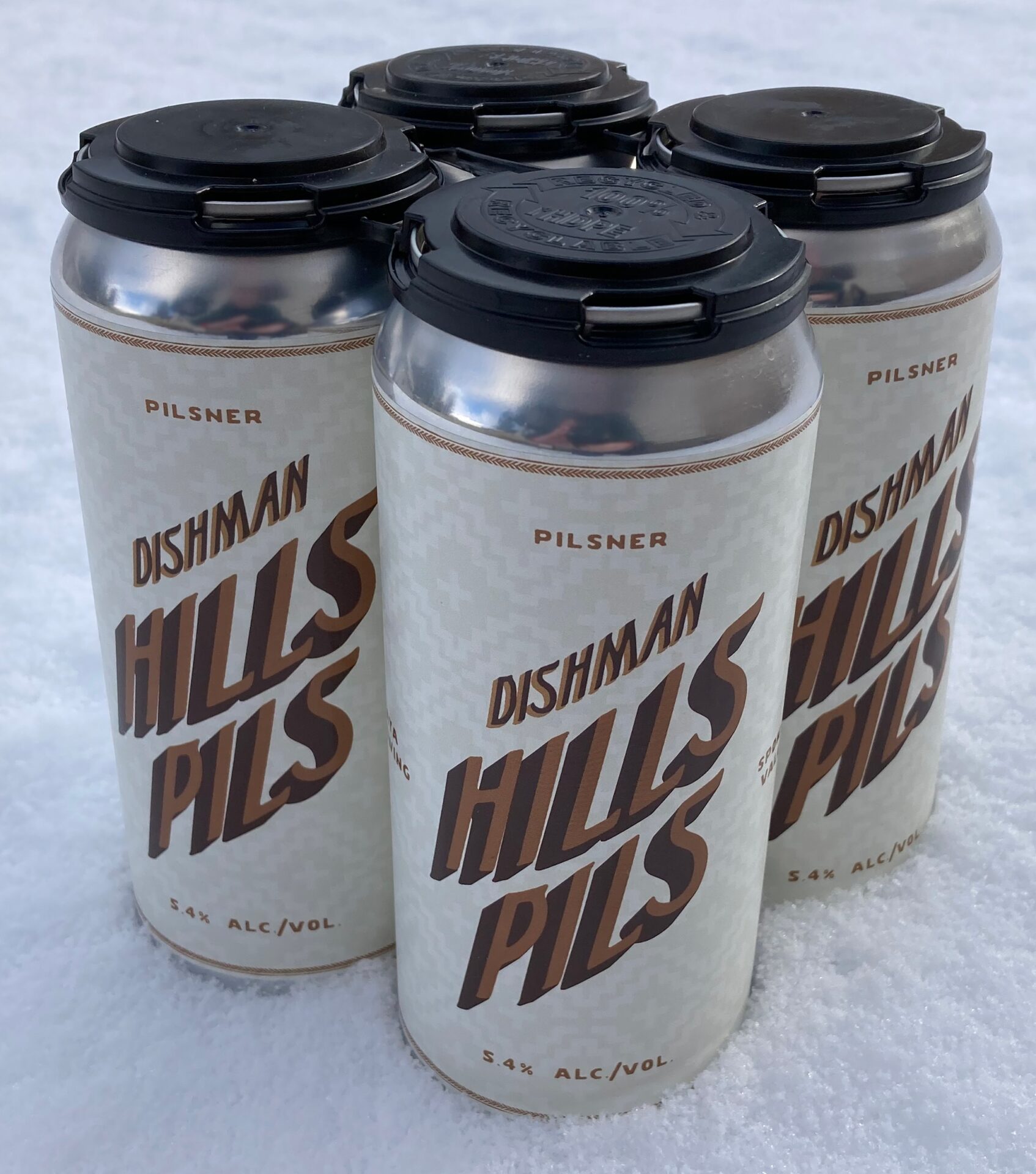 Dishman Hills Pils from Yaya Brewing - 4 cans sitting on snow.