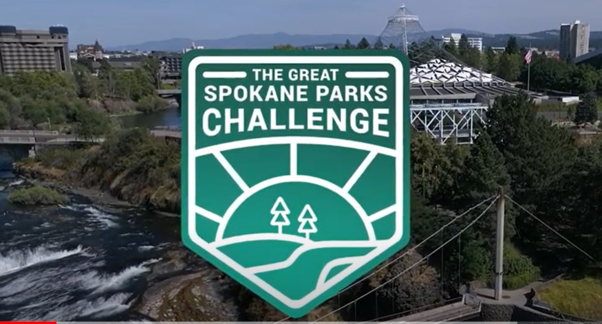 Green and white colored graphic logo for The Great Spokane Parks Challenge with outline of trees, sun, and trail.