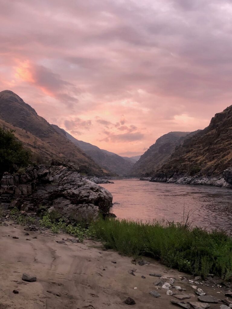Pink and purple sunset hues in the sky above the Snake River at Hells Canyon.