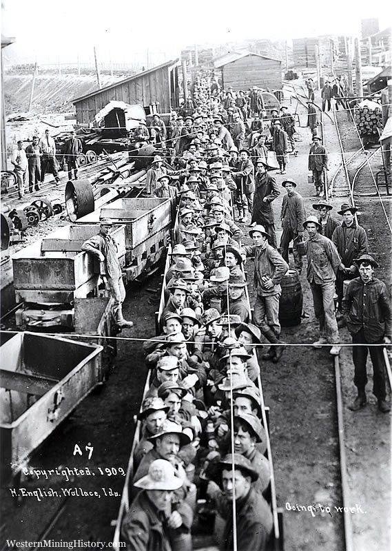 Historic black and white photos of male miners, all males, in minding cars, wearing work uniforms and hats, looking stoically at the camera.