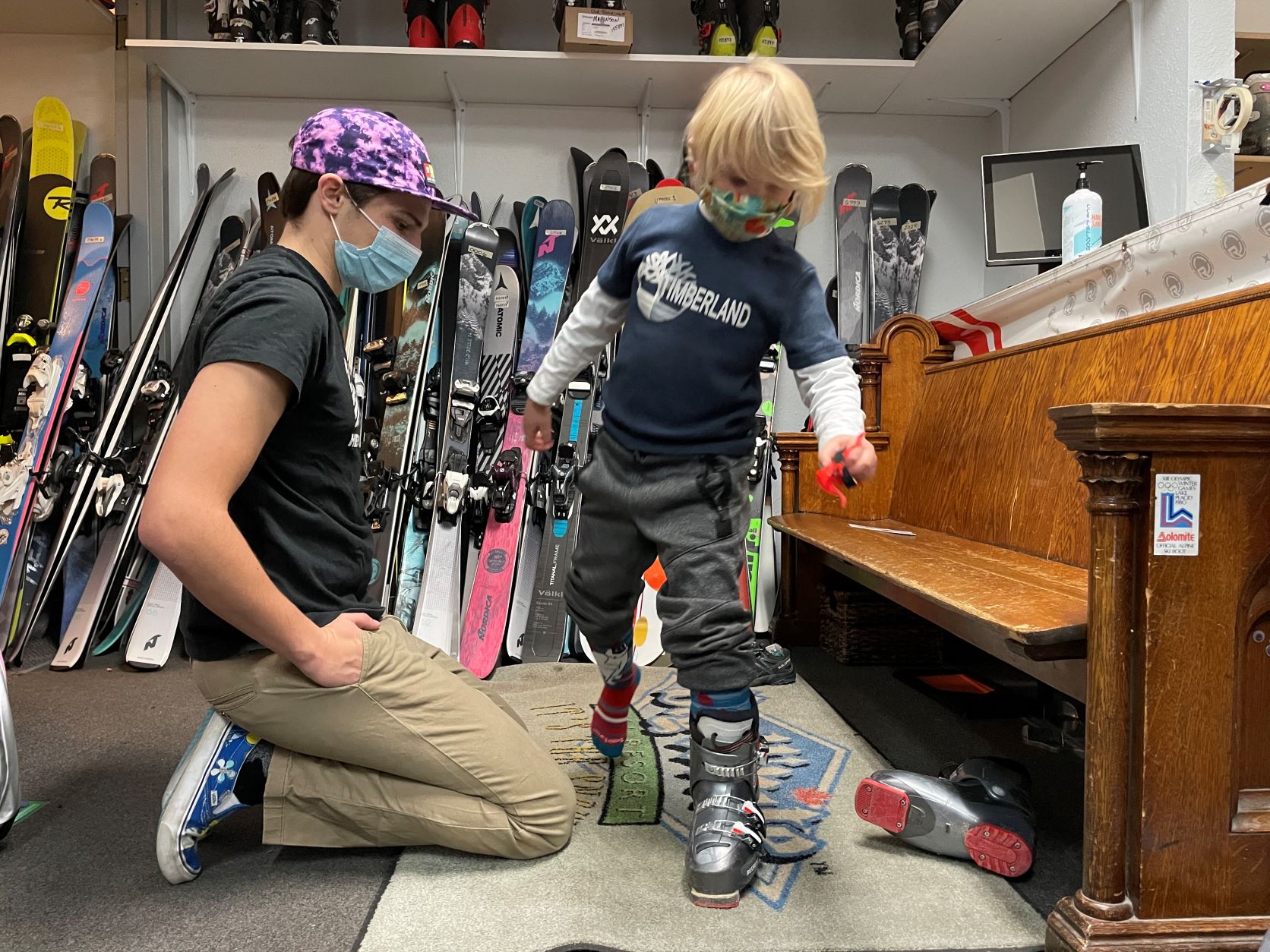 Child trying on ski boot to get properly-fitted for the next size of seasonal lease gear.